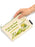 A hand holds a cream-colored canvas pouch featuring the classic 'Frog and Toad Are Friends' illustration and text by Arnold Lobel. The pouch has a light green zipper and a black fabric brand tag on the right side that reads 'OUT OF PRINT'
