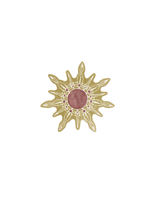 Decorative sun-shaped object with a pink center on a white background