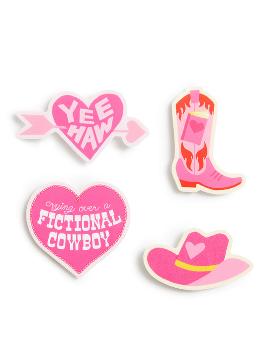 Four pink and white western-themed die-cut stickers on a white background, including a heart with 'YEE HAW', a boot with a heart, a heart reading 'CRYING OVER A FICTIONAL COWBOY', and a cowboy hat with a pink heart and yellow band.