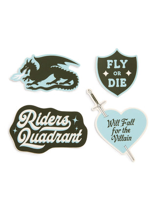 Four fantasy-themed enamel pins on a plain white background: a dark green dragon pin with light blue accents, a dark green shield pin reading 'FLY OR DIE', a dark green irregular shape pin reading 'Riders Quadrant', and a light blue heart pin with a silver sword and the phrase 'Will Fall for the Villain'.