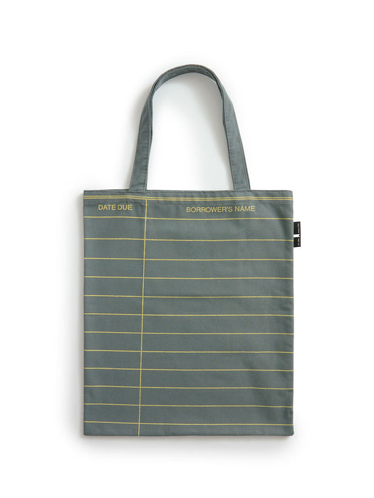 A slate gray fabric tote bag with gold horizontal lines resembling a ledger page, featuring gold text reading 'DATE DUE' and 'BORROWER'S NAME' on the top border, set against a plain white background.