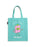 A light teal canvas tote bag featuring a cute pink book character with a smiling face, the words 'STILL HERE' above it, and 'Still Queer' written below in white script.