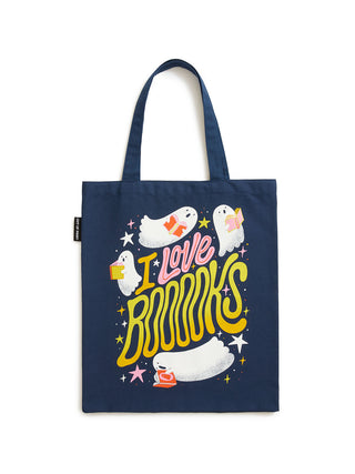 A navy blue canvas tote bag featuring a colorful graphic print with cartoon ghosts, stars, and the text 'I Love BOOKS' in yellow and pink, shown against a plain white background.