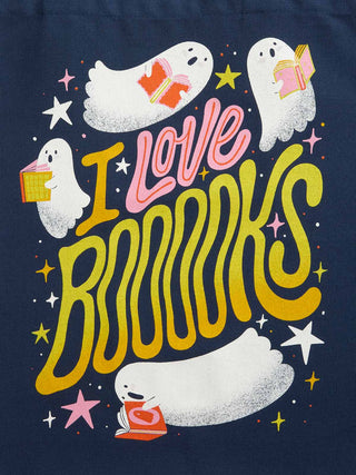 A graphic print on a navy blue background featuring cute white cartoon ghosts reading books, surrounded by stars and wavy yellow and pink text that reads 'I Love BOOKS'.