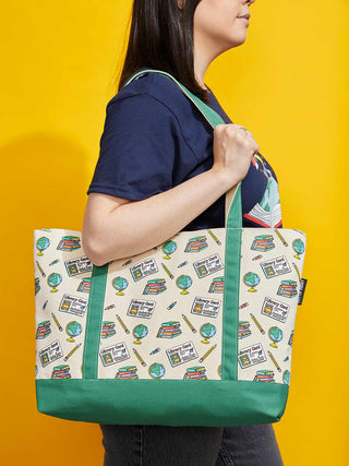 Person holding a tote bag with Arthur references against a yellow background