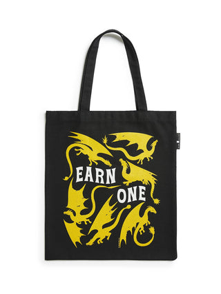 Black tote bag with yellow dragon design and 'Earn One' text on a white background
