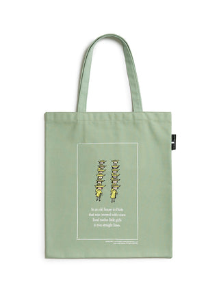 Green tote bag with printed design and text on a white background