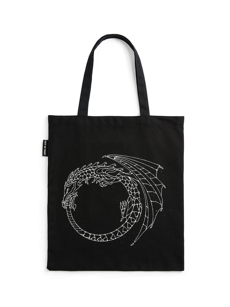 Black tote bag with white dragon design on a white background