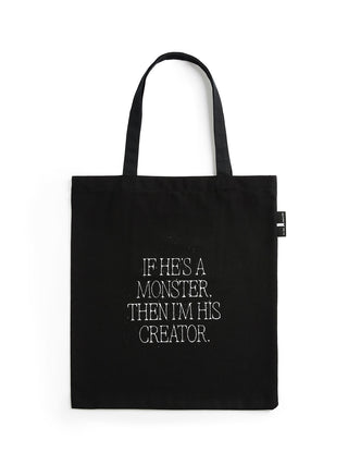Black tote bag with white text on a white background