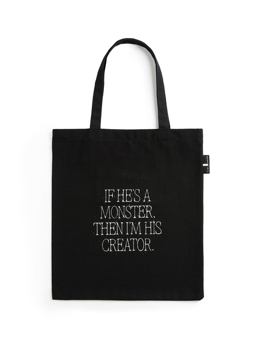 Black tote bag with white text on a white background