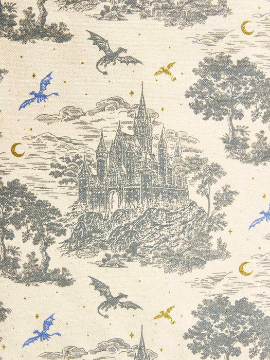 A close-up of a fabric or wallpaper pattern featuring a detailed black ink-style illustration of a castle on a hill, surrounded by trees, clouds, stars, crescent moons, and dragons on an off-white background.