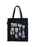 A black canvas tote bag with two shoulder straps, featuring a graphic print titled 'Plants of Panem' with various illustrated plants in pastel colors and small labels, shown against a plain white background.