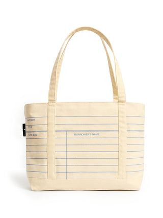 A cream-colored canvas tote bag with blue lined notebook-style writing guides and two shoulder straps, shown on a plain white background.