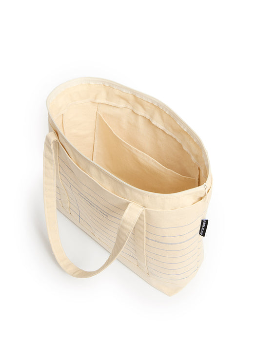 A cream-colored canvas tote bag with a striped pattern and dual shoulder straps, shown from an overhead angle on a white background.