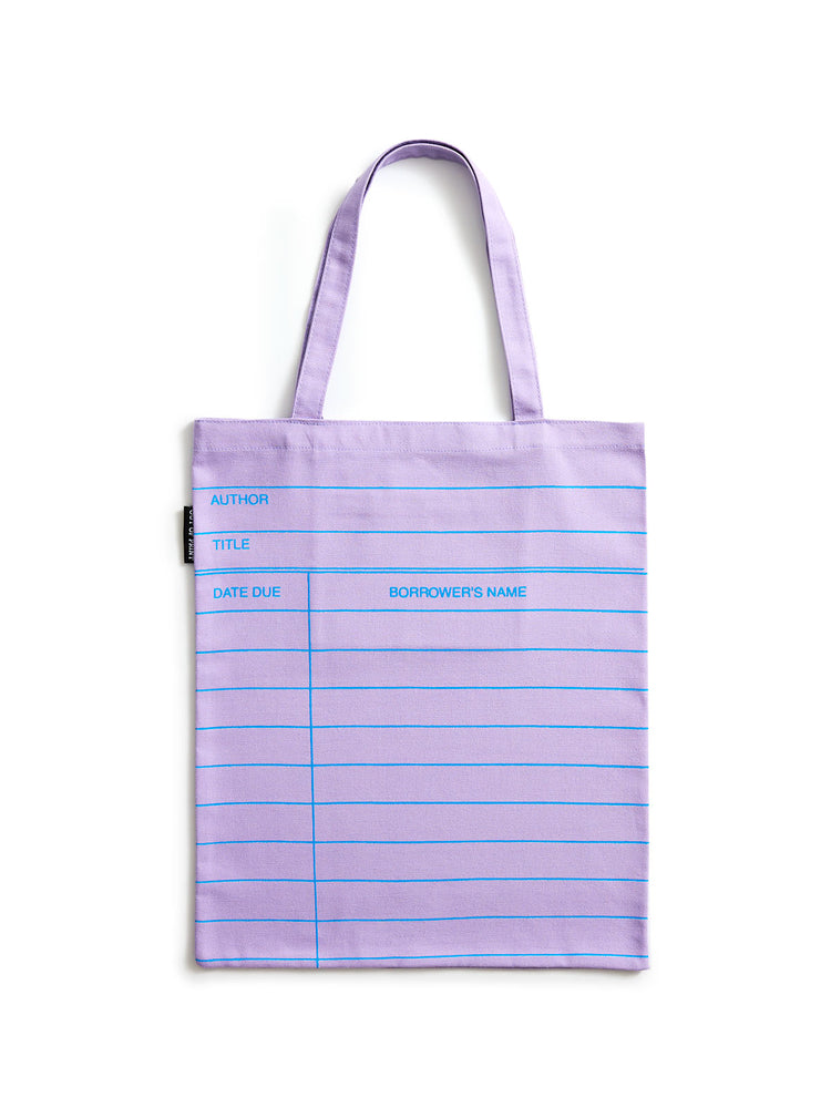 A lilac purple tote bag with blue horizontal lines and printed writing fields, shown against a plain white background.