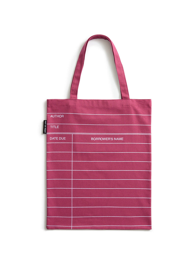 A maroon red canvas tote bag with white horizontal lines and printed text fields for author, title, date due, and borrower's name, shown on a plain white background.