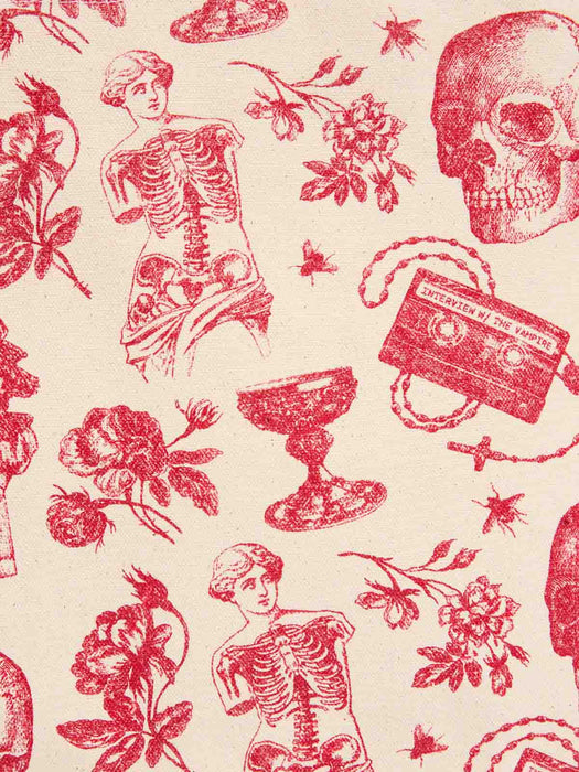 A close-up of a toile pattern featuring red gothic-style illustrations on a warm cream background, including classical statues, human skeletons, skulls, flowers, a goblet, and a cassette tape.