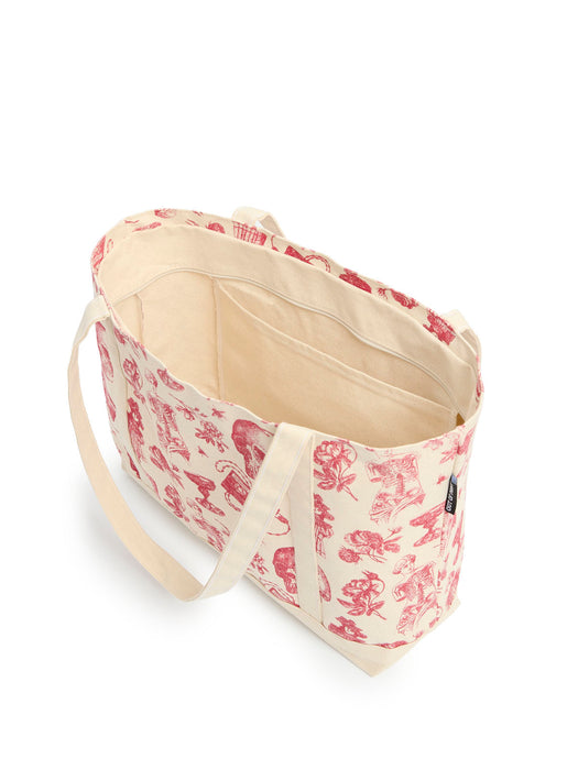A canvas tote bag with a red toile-style print on a cream background, featuring a cream canvas interior, interior pocket, and matching shoulder straps, shown on a white background.