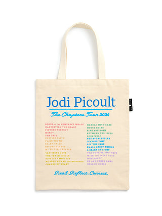A cream-colored canvas tote bag with white shoulder straps, featuring blue and multicolor printed text on the front that reads 'Jodi Picoult The Chapters Tour 2026' with a list of her book titles and the words 'Read. Reflect. Connect.' at the bottom.
