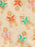 Beige fabric with a repeating pattern of gingerbread cookies reading colorful books in pink, green, and orange.