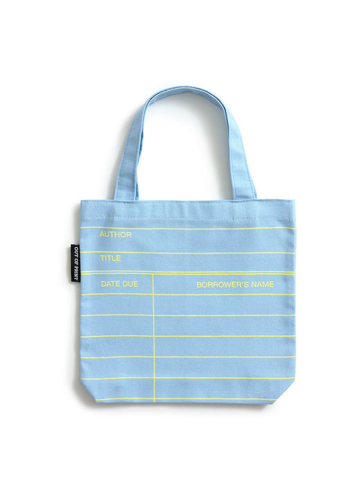 A light cloud blue canvas tote bag with yellow grid lines and text fields for author, title, date due, and borrower's name, shown on a white background.
