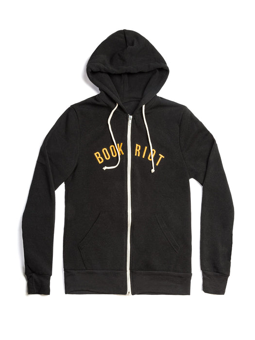A black zip-up hoodie with white drawstrings and a white front zipper, featuring the words 'BOOK RIOT' printed in yellow across the chest, displayed on a clean white background.